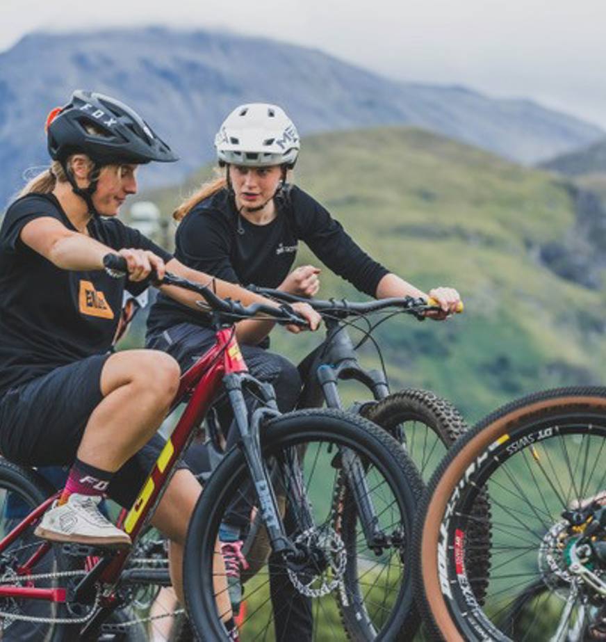 Millie Jackson (left) and Isabelle Hogan chatting while they rider their bikes around the track at Fort William Bike Park. Millie is on one of the park’s  fleet bikes which are free to use.